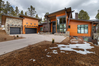 Mid-sized modern house exterior idea in Phoenix with a metal roof and a black roof