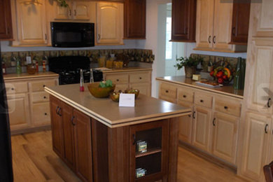 Example of a medium tone wood floor open concept kitchen design in Other with raised-panel cabinets, light wood cabinets, laminate countertops, beige backsplash, ceramic backsplash and an island