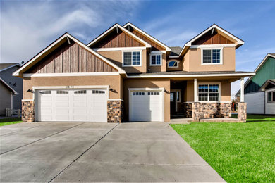 Example of a mid-sized arts and crafts brown two-story stucco exterior home design in Denver with a shingle roof