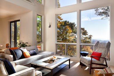 Example of a trendy open concept light wood floor living room design in Charlotte with no tv