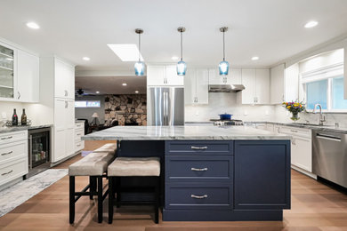 Mid-sized beach style eat-in kitchen photo in San Francisco with marble countertops, white backsplash, an island, white countertops, white cabinets, subway tile backsplash and stainless steel appliances