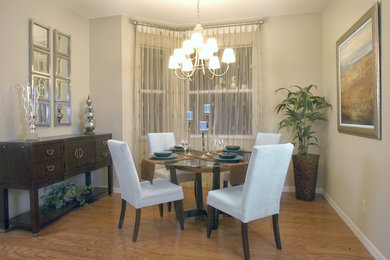 Example of a large trendy medium tone wood floor and brown floor great room design in Miami with beige walls and no fireplace