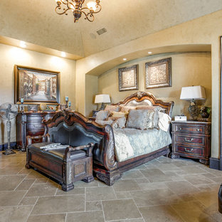 Idée de décoration pour une grande chambre parentale tradition avec un mur beige, un sol en calcaire, un sol beige, une cheminée standard et un manteau de cheminée en bois.