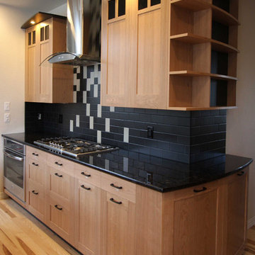 Detail of curved end cabinet, shelving and light valence