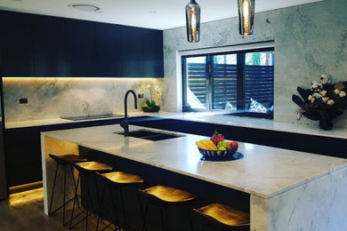 Inspiration for a l-shaped kitchen in Sydney with black cabinets and with island.