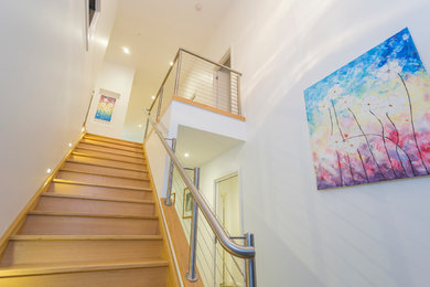 This is an example of a contemporary wood straight staircase in Geelong.