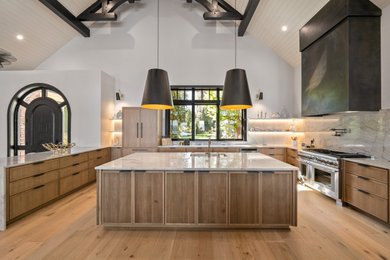 Inspiration for a large transitional u-shaped light wood floor, brown floor and shiplap ceiling open concept kitchen remodel in Seattle with an undermount sink, recessed-panel cabinets, light wood cabinets, quartzite countertops, gray backsplash, stone slab backsplash, stainless steel appliances, an island and gray countertops