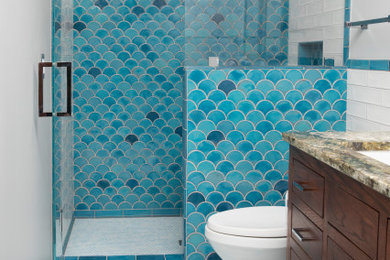 Inspiration for a mid-sized contemporary master blue tile and ceramic tile ceramic tile, white floor and single-sink doorless shower remodel in Minneapolis with recessed-panel cabinets, dark wood cabinets, white walls, a drop-in sink, granite countertops, a hinged shower door, brown countertops, a niche and a freestanding vanity