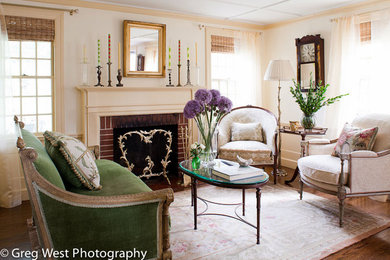 Living room - mid-sized transitional formal and enclosed medium tone wood floor living room idea in Manchester with beige walls, a standard fireplace, a brick fireplace and no tv