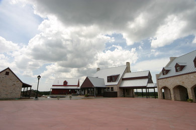 Huge southwest multicolored two-story mixed siding exterior home photo in Austin with a metal roof