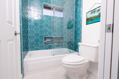 Example of a mid-sized island style kids' blue tile and porcelain tile porcelain tile, beige floor, double-sink and wallpaper bathroom design in San Diego with raised-panel cabinets, blue cabinets, white walls, an undermount sink, quartz countertops, white countertops and a built-in vanity