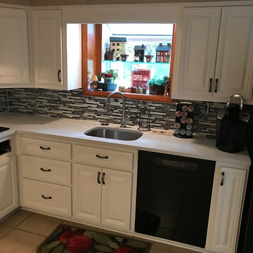 cabinet refacing--white with quartz countertops and glass backsplash