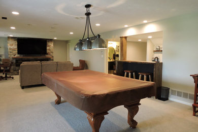 Inspiration for a transitional walk-out carpeted and gray floor basement remodel in Omaha with a bar and gray walls