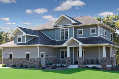 Example of a mid-sized arts and crafts beige three-story mixed siding exterior home design in Other