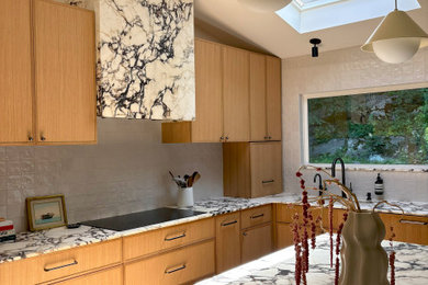Example of a mid-sized minimalist l-shaped medium tone wood floor eat-in kitchen design in New York with an undermount sink, shaker cabinets, light wood cabinets, marble countertops, white backsplash, porcelain backsplash and purple countertops
