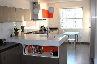 This is an example of a mid-sized modern single-wall separate kitchen in Paris with a double-bowl sink, beaded inset cabinets, quartzite benchtops, white splashback, glass sheet splashback, stainless steel appliances, ceramic floors and with island.