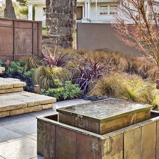 Photo of a large arts and crafts courtyard patio in San Francisco with a water feature.