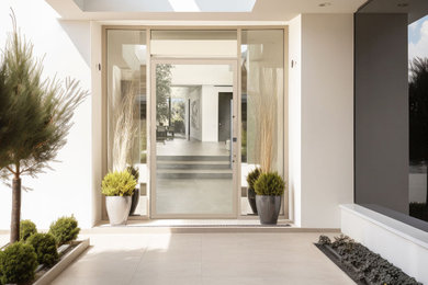 Entryway - contemporary entryway idea in Los Angeles with a glass front door