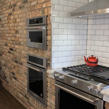 Atkinson, IL- Ranch Home Remodel With Bright White Cabinets and Brick Wall
