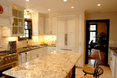 Example of a large classic l-shaped ceramic tile enclosed kitchen design in Minneapolis with a double-bowl sink, raised-panel cabinets, light wood cabinets, granite countertops, beige backsplash, subway tile backsplash, paneled appliances and an island