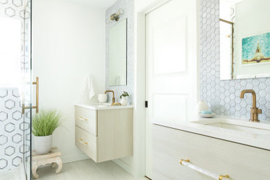 Bathroom - mid-sized coastal master blue tile and ceramic tile porcelain tile, beige floor and double-sink bathroom idea in Tampa with flat-panel cabinets, light wood cabinets, white walls, an undermount sink, quartz countertops, white countertops and a floating vanity