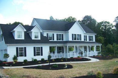 Huge elegant white two-story exterior home photo in Other