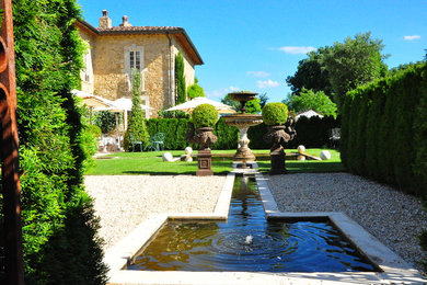 Inspiration for a large mediterranean partial sun backyard gravel landscaping in New York for summer.