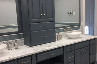 Large transitional master white tile and marble tile marble floor and white floor bathroom photo in Other with raised-panel cabinets, gray cabinets, a two-piece toilet, gray walls, a vessel sink, marble countertops and a hinged shower door