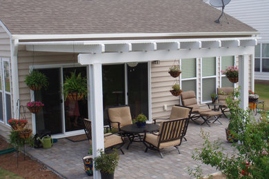 Mid-sized elegant backyard brick patio photo in Charleston with a pergola