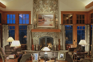 Example of a large classic open concept medium tone wood floor living room design in Denver with white walls, a standard fireplace, a stone fireplace and no tv