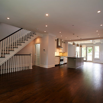Open-Concept Living Room with Modern Kitchen and Wooden Staircase