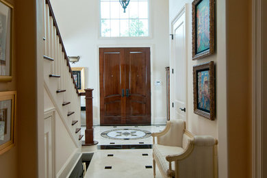 Photo of a traditional front door in New Orleans with white walls, marble floors, a double front door and a dark wood front door.