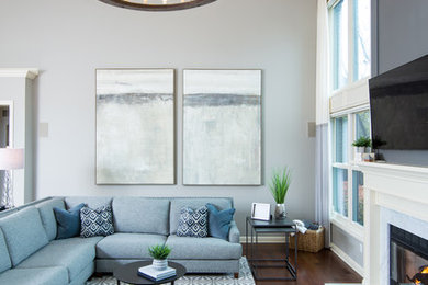 Inspiration for a mid-sized transitional open concept dark wood floor and brown floor living room remodel in Detroit with gray walls, a standard fireplace, a stone fireplace and a wall-mounted tv