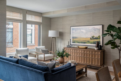 Mid-sized transitional open concept medium tone wood floor and wallpaper living room photo in DC Metro with beige walls and a wall-mounted tv