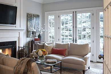Example of a large transitional medium tone wood floor living room design in Toronto with a standard fireplace, a stone fireplace and a media wall
