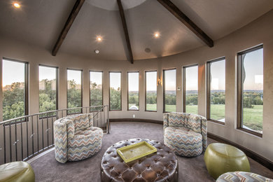 Example of a mid-sized trendy enclosed carpeted and beige floor family room library design in Other with beige walls and no tv