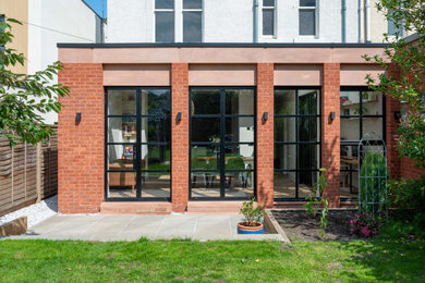 Inspiration for a mid-sized contemporary red one-story brick exterior home remodel in Edinburgh