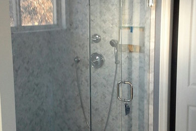 Design ideas for a mid-sized modern 3/4 bathroom in Denver with a drop-in tub, a corner shower, gray tile, marble, grey walls, marble floors, grey floor and a hinged shower door.