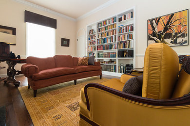 Inspiration for a mid-sized transitional enclosed dark wood floor and brown floor living room remodel in Philadelphia with beige walls, no tv, a standard fireplace and a brick fireplace