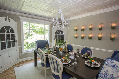 Small traditional separate dining room in DC Metro with grey walls and light hardwood floors.