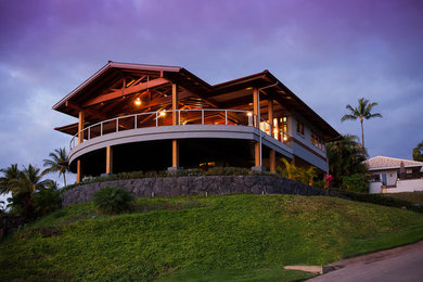 Tropical two-storey exterior in Hawaii with mixed siding.