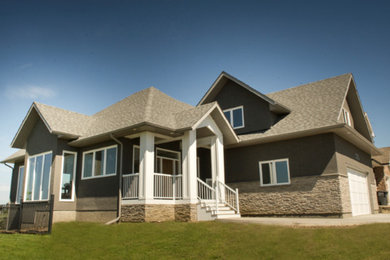 Inspiration for a large contemporary beige two-story stucco gable roof remodel in Other