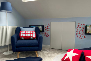Design ideas for a nursery for boys in London with blue walls, carpet and beige floors.