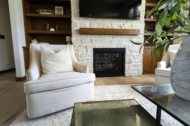 Example of a transitional formal light wood floor and beige floor living room design in Other with a standard fireplace, a stone fireplace and a wall-mounted tv