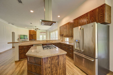 Example of a huge minimalist l-shaped ceramic tile and brown floor open concept kitchen design in Houston with an undermount sink, flat-panel cabinets, dark wood cabinets, granite countertops, brown backsplash, ceramic backsplash, stainless steel appliances, two islands and brown countertops