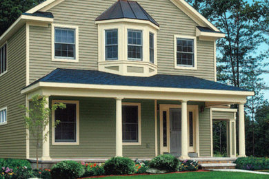 This is an example of a mid-sized two-storey green exterior in Cincinnati with wood siding and a gable roof.