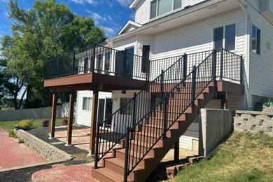 Deck - mid-sized backyard second story metal railing deck idea in Seattle