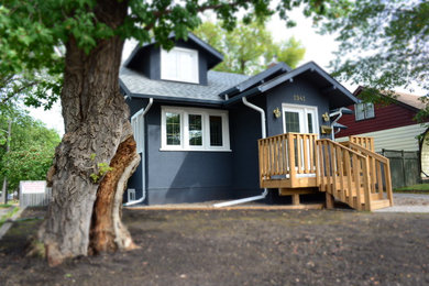 Mid-sized 1960s blue two-story stucco gable roof idea in Other