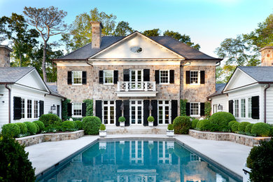 Large traditional backyard rectangular pool in Atlanta with a water feature.