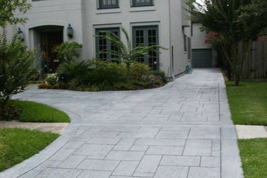 This is an example of a large traditional front yard concrete paver landscaping in Toronto.